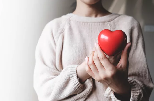 woman holding red heart 