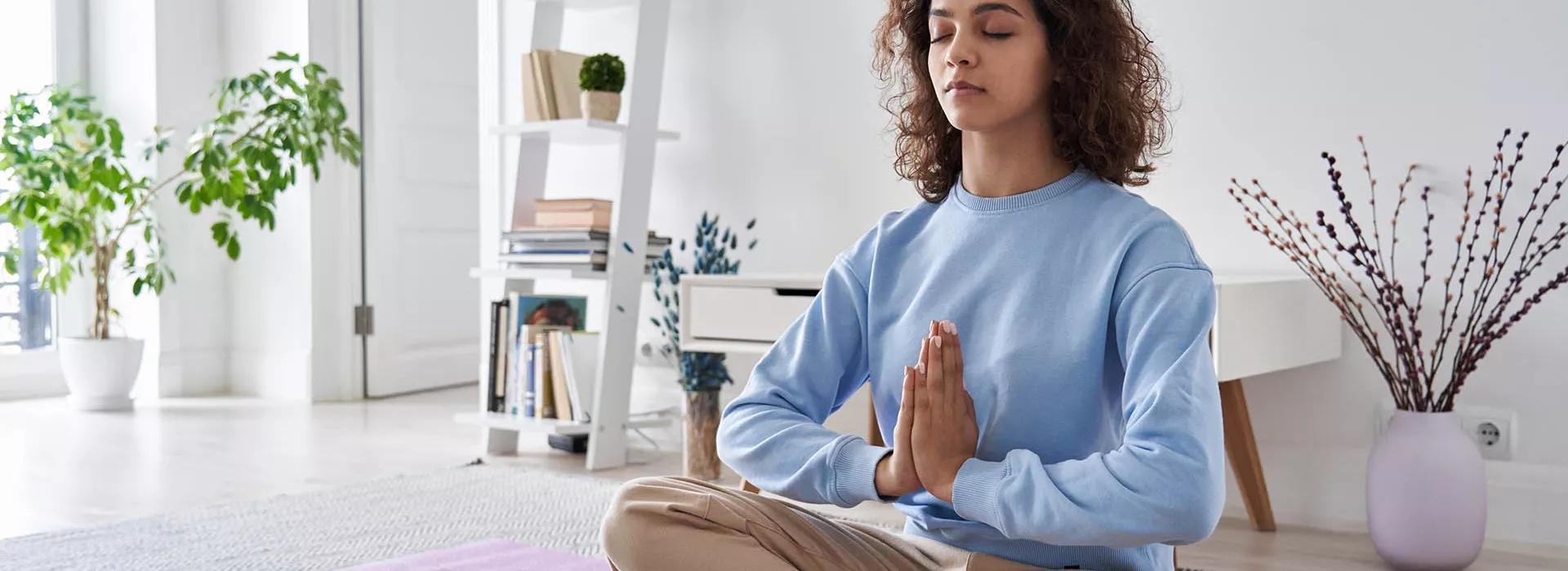 woman doing yoga inside